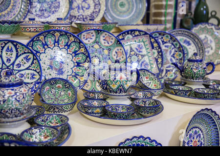 Sale of traditional Uzbek dishes in a souvenir shop at the Samarkand market Stock Photo