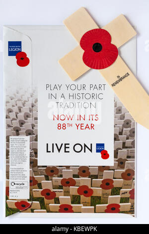 red poppy on wooden cross in remembrance with correspondence envelope from The Royal British Legion - play your part in a historic tradition Stock Photo