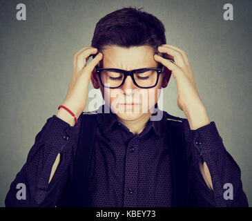 Closeup portrait sad young man with worried stressed face expression looking down Stock Photo