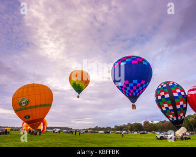 York, UK. 30th September, 2017. A mass balloon launch took place at sunrise from York Knavesmire as part of the first ever York Balloon Fiesta. Over 30 balloons took to the skies watched by hundreds of onlookers. The launch is part of a three day event which runs until Sunday the 1st of October. Photo Bailey-Cooper Photography/Alamy Live News Stock Photo