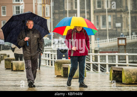 Aberystwyth, Wales, UK, Saturday 30 September 2017 UK Weather: Torrential rain pours down on pedestrians sheltering under their umbrellas at the seaside in Aberystwyth inWest Wales. Storm Brian, the second named storm of the season, is expected to bring more rain and gale force winds to the west and north of the UK on Sunday and Monday. Yellow warnings have ben issued by the Met Office Photo Credit: Keith Morris/Alamy Live News Stock Photo