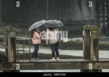 Aberystwyth, Wales, UK, Saturday 30 September 2017 UK Weather: Torrential rain pours down on pedestrians sheltering under their umbrellas at the seaside in Aberystwyth inWest Wales. Storm Brian, the second named storm of the season, is expected to bring more rain and gale force winds to the west and north of the UK on Sunday and Monday. Yellow warnings have ben issued by the Met Office Photo Credit: Keith Morris/Alamy Live News Stock Photo