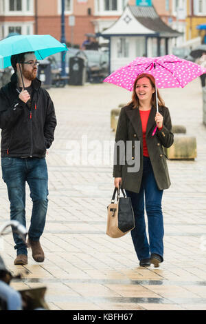 Aberystwyth, Wales, UK, Saturday 30 September 2017 UK Weather: Torrential rain pours down on pedestrians sheltering under their umbrellas in Aberystwyth inWest Wales. Storm Brian, the second named storm of the season, is expected to bring more rain and gale force winds to the west and north of the UK on Sunday and Monday. Yellow warnings have ben issued by the Met Office Photo Credit: Keith Morris/Alamy Live News Stock Photo