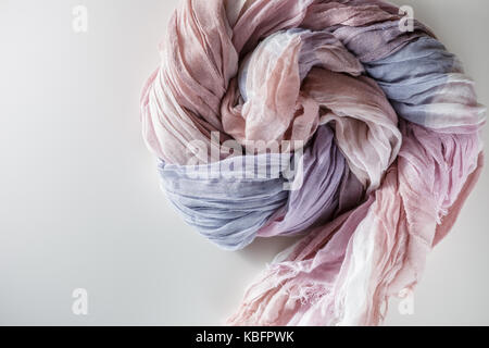 Gradient purple, pink, beige cloth twisted in spiral Stock Photo