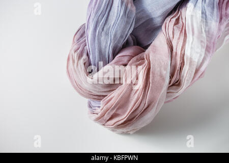 Gradient purple, pink, beige cloth twisted in spiral Stock Photo