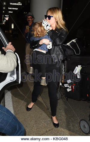 Holly Valance and her daughter arrive at Los Angeles International ...
