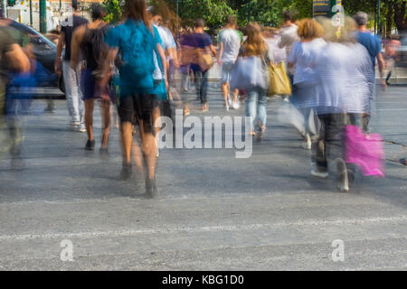 Blurry people walking in the street of Athens Stock Photo