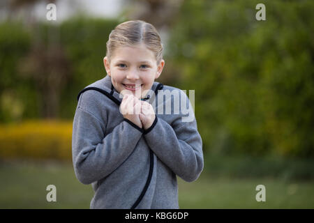 Portrait of young girl standing in the park Stock Photo