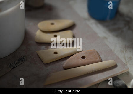Close-up of work tools on worktop in pottery workshop Stock Photo