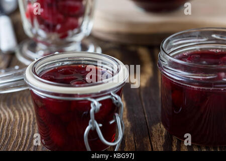 Dogwood jam and ripe cornel berries  on rural wooden background Stock Photo