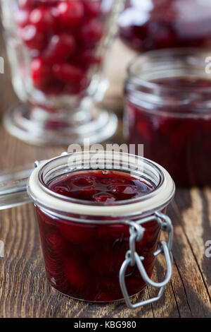 Dogwood jam and ripe cornel berries  on rural wooden background Stock Photo