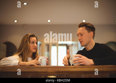 Couple interacting with each other while having coffee at home Stock Photo