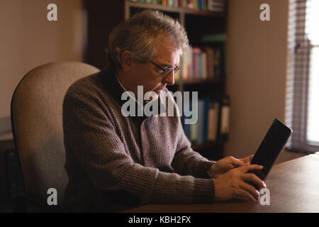 Senior man using digital tablet at home Stock Photo