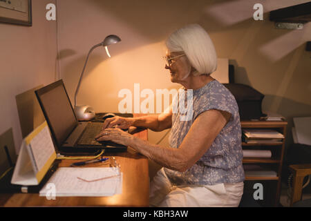 Senior woman working on laptop at home Stock Photo