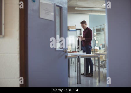 Architect using digital tablet at table in studio Stock Photo