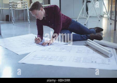 Architect working on blueprint in studio Stock Photo