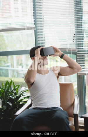 Man using virtual reality headset in the living room at home Stock Photo