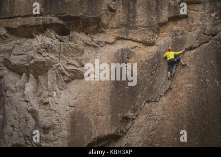 Rear view of man climbing mountain Stock Photo