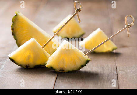 sliced pineapple on wood background, popular fruit in summer season Stock Photo