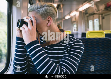 Man taking picture with digital camera while travelling in metro Stock Photo
