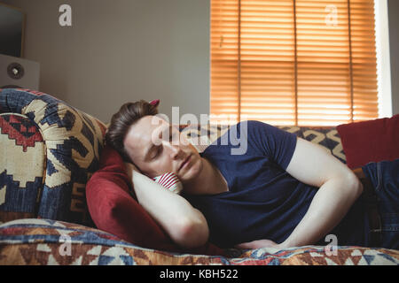 Man sleeping on sofa at home Stock Photo