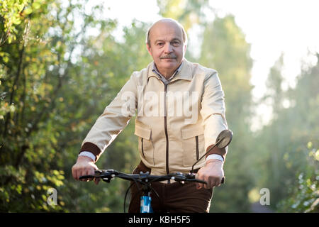 Senior man on cycle ride in countryside Stock Photo