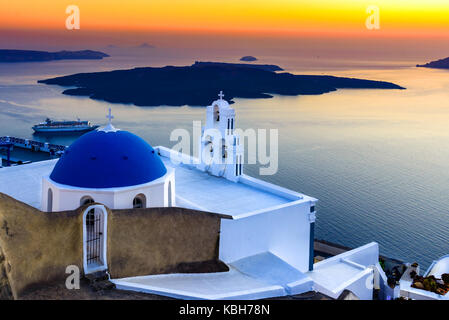 Firostefani, Santorini, Greece. twilight with old greek church and caldera at Aegean Sea - Greek Islands landmark Stock Photo