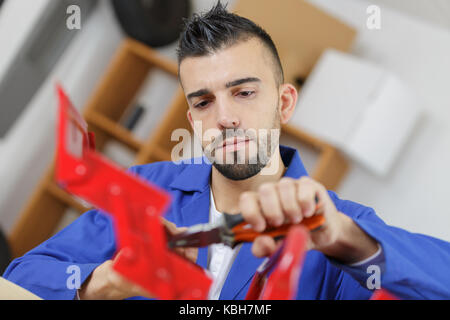 handyman searching in his tool box for the necessary tools Stock Photo