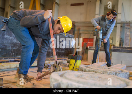 constructions workers drilling concrete Stock Photo