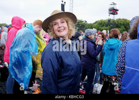 Dancing in the rain wearing anoraks and kagools at Hyde Park London Stock Photo