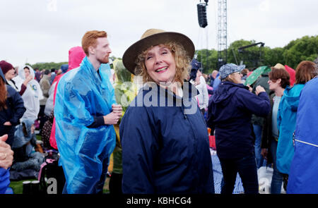 Dancing in the rain wearing anoraks and kagools at Hyde Park London Stock Photo