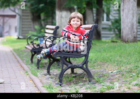 boy kid bench parl alone Stock Photo