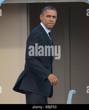 U.S. President Barack Obama departs the Oval Office at the White House ...