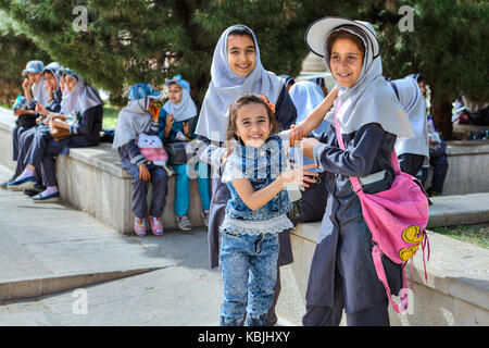 Fars Province, Shiraz, Iran - 19 april, 2017: Iranian schoolgirls are resting in the city garden during a school excursion. Stock Photo