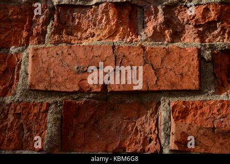 Solid one-piece vintage red brick in the crumbling brick wall Stock Photo