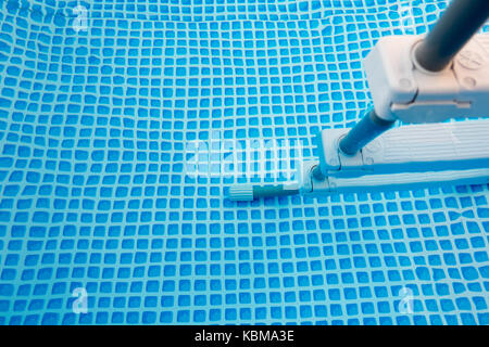 Stairs in swimming pool close up, pool filled with water, small blue tiles pattern Stock Photo