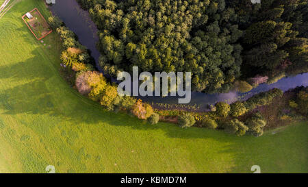 Aerial view of river bend through forest. Stock Photo