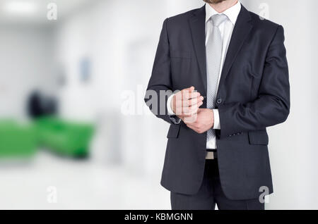 Portrait of unrecognizable businessman standing in modern white office concept Stock Photo