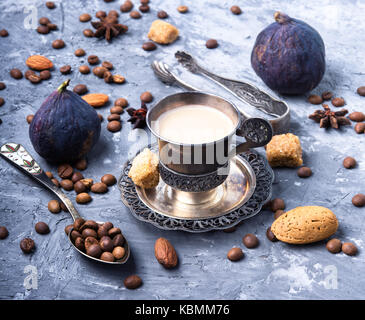 stylish metallic coffee cup on a coffee background Stock Photo
