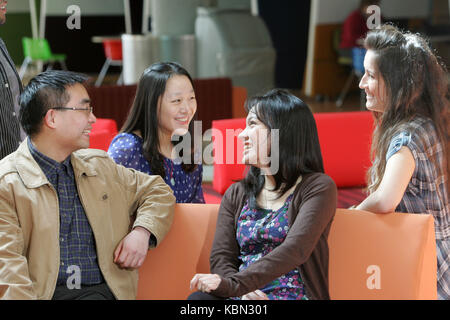 International students socialising together on campus Stock Photo