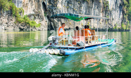 YANGSHUO, CHINA - SEPTEMBER 23, 2016: Tourist cruise boat on a Li river in Yangshuo, famous travel spot in Guilin area in Gaungxi province Stock Photo