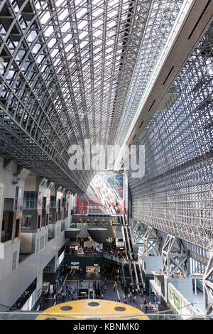 Kyoto station. Massive building designed by Hiroshi Hara. View from high floor at one end looking along interior of station, with roof and concourse. Stock Photo