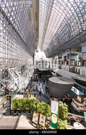 Kyoto station. Massive building designed by Hiroshi Hara. View from high floor at one end looking along interior of station, concourse and glass roof. Stock Photo