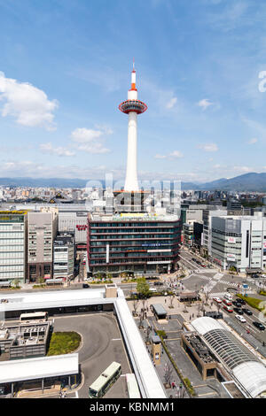 Japan, Kyoto. The iconic Kyoto tower and tower hotel with station bus terminus in foreground. Daytime. View from upper floor of Kyoto station. Stock Photo