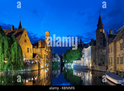 Bruges, Belgium. The Dijver canal at night looking towards the Bourgoensch Hof Hotel and Belfry (Belfort), Brugge, Belgium. Stock Photo