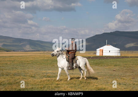 Huvsgul, Mongolia, September 6th, 2017: mongolian man riding a horse in northern mongolian landscape Stock Photo