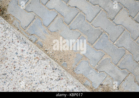 Joint of Concrete and Paving Stones from the Sidewalk. Paving stones on a footpath Stock Photo