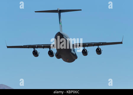 United States Air Force C-17, Globemaster III, Heavy Lift Aircraft, Descending Into The Panamint Valley, California. Stock Photo