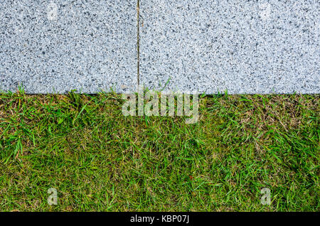 Gray Granite Pavement and Grass Lawn in Garden Decorative Texture Stock Photo