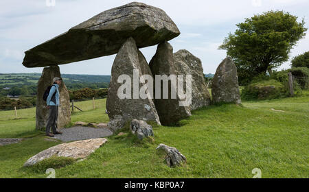Gazing up at the enormity of the 16 tonne capstone of Pentre Ifan Burial Chamber, Nevern, Wales, United Kingdom Stock Photo